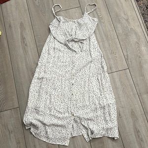 Adjustable thin strap dress. Top to bottom button closure. Tie closure in front